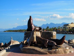 A statue of seals in the Loreto marina.