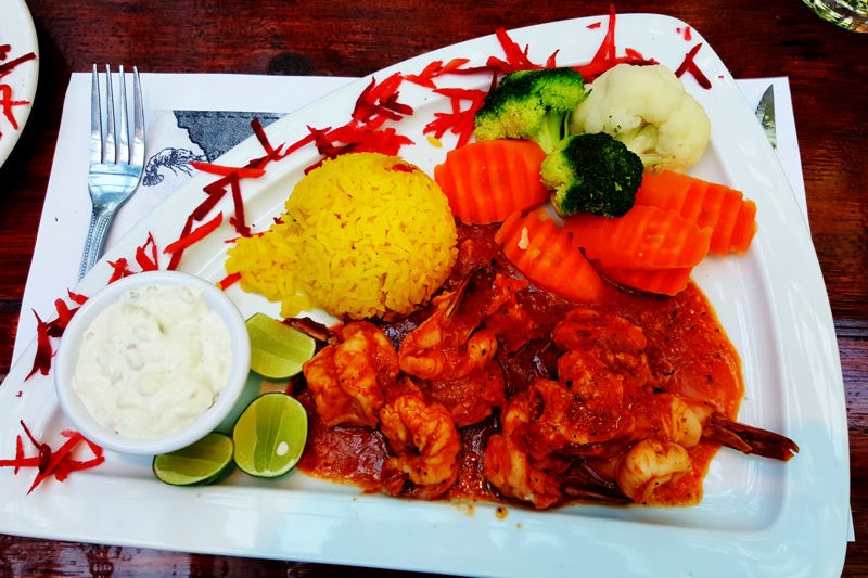Camarones diavolo with vegetables and rice at Domingos Place.